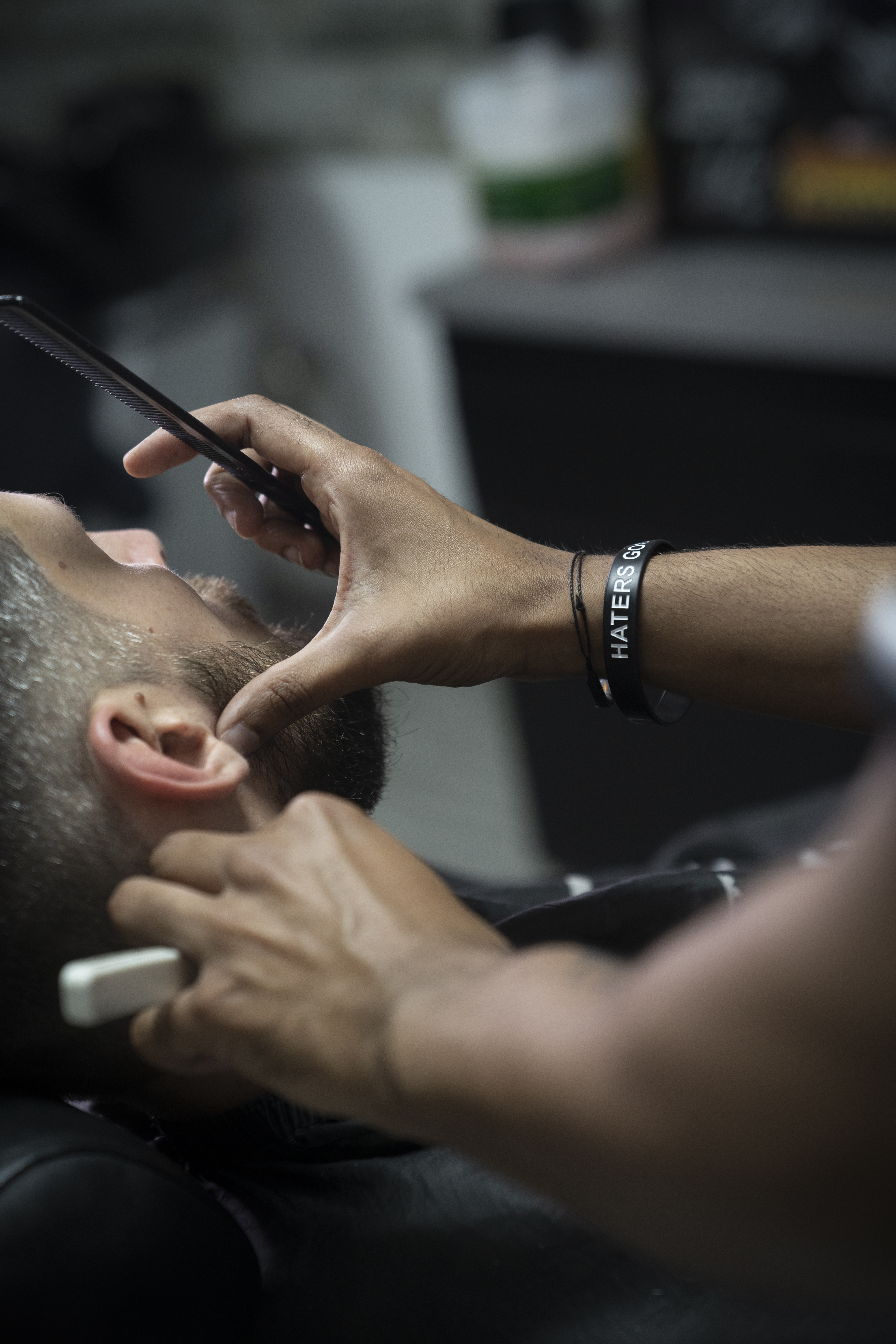 A barber giving a shave with a straight razor