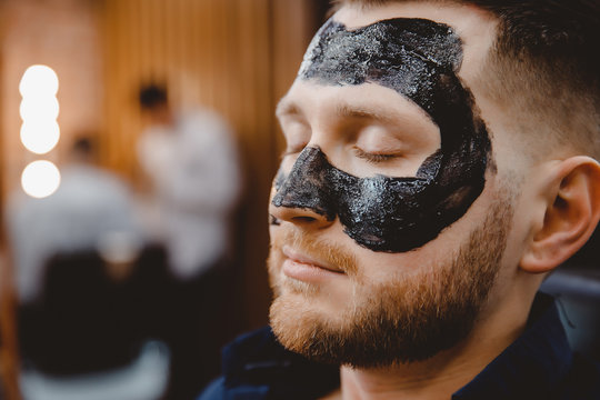 A barber giving a shave with a straight razor