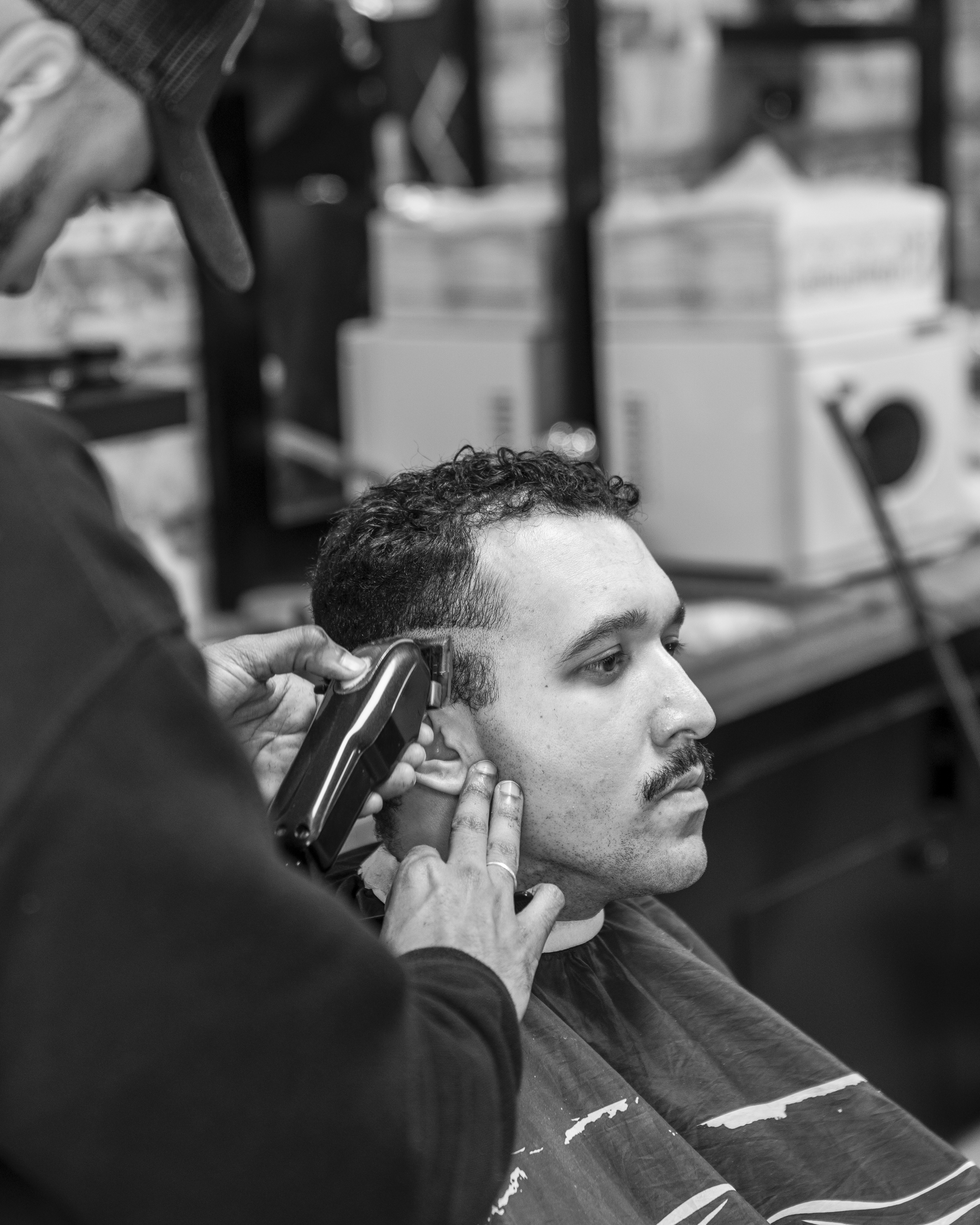 A barber giving a shave with a straight razor