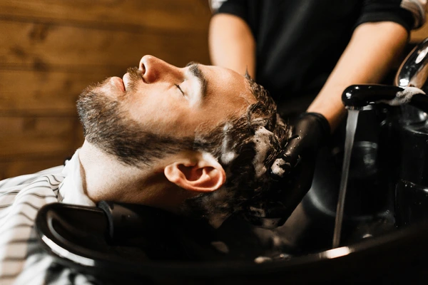 A barber styling a beard with precision